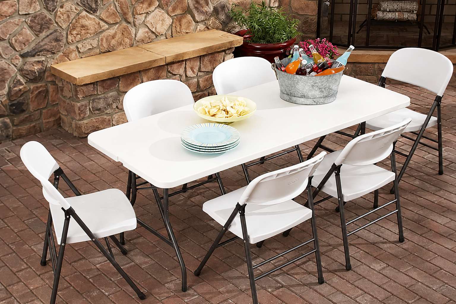6ft rectangular folding table with six white chairs available for rent in Winnipeg Manitoba