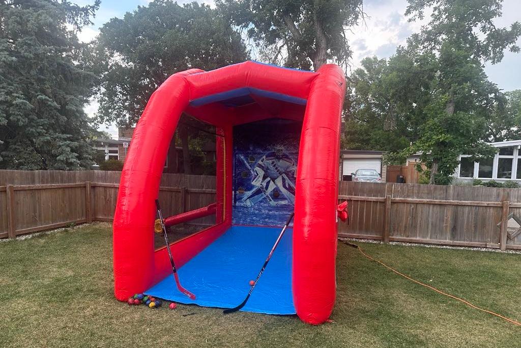 Sports game rental with hockey target backdrop in Winnipeg Manitoba