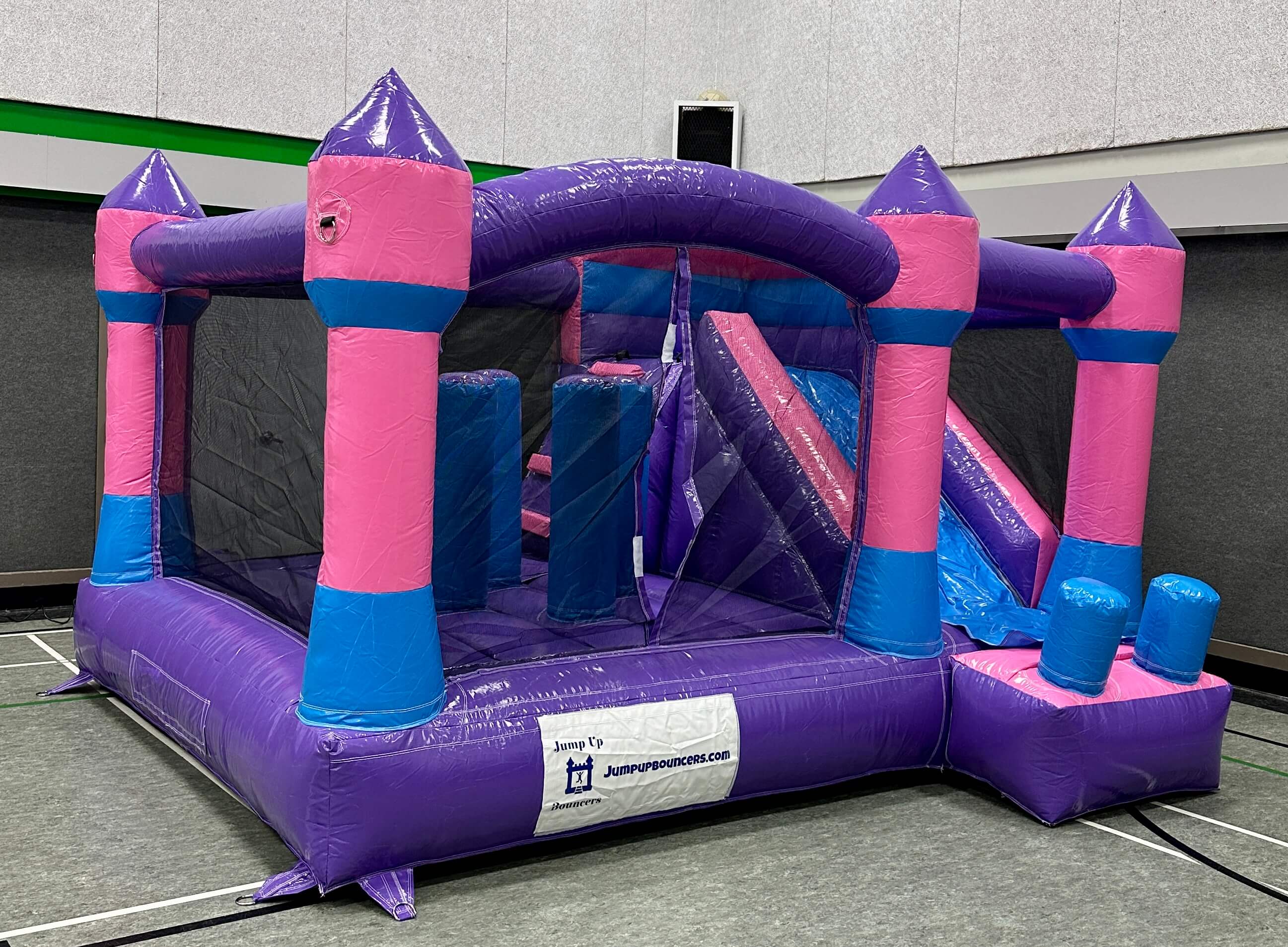 Indoor friendly pink and purple jump and slide bouncy castle rental in Manitoba
