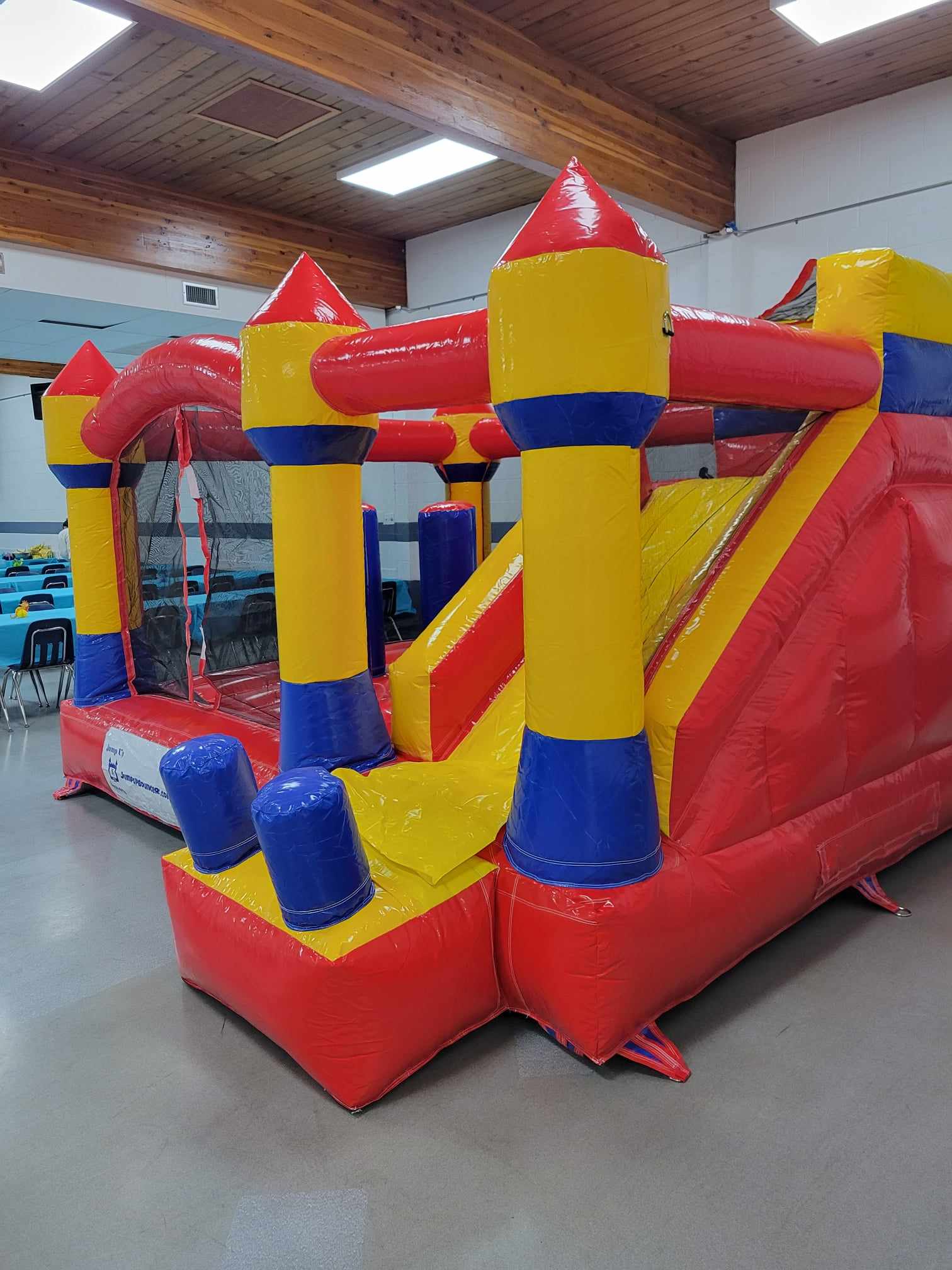 Yellow and red inflatable bouncy castle with slide for birthday parties in Winnipeg
