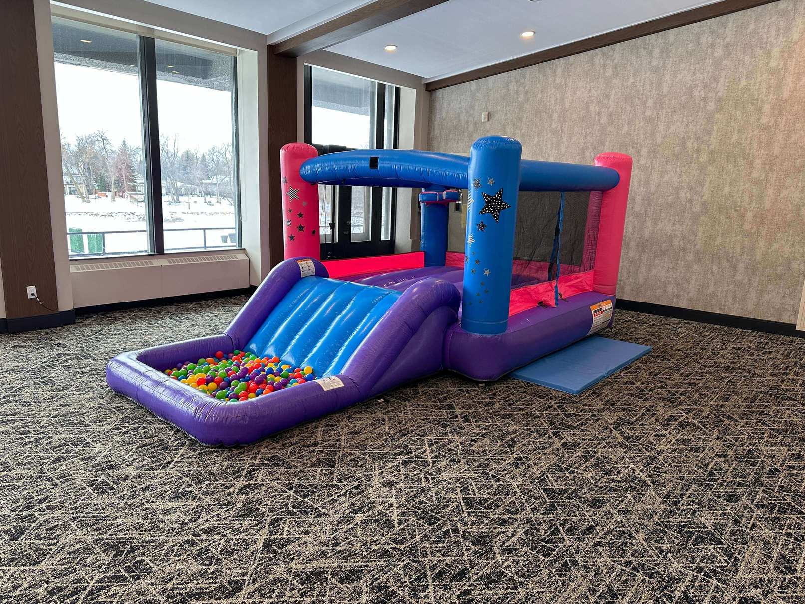 Kids inflatable slide and bounce house rental with basketball hoop in Winnipeg