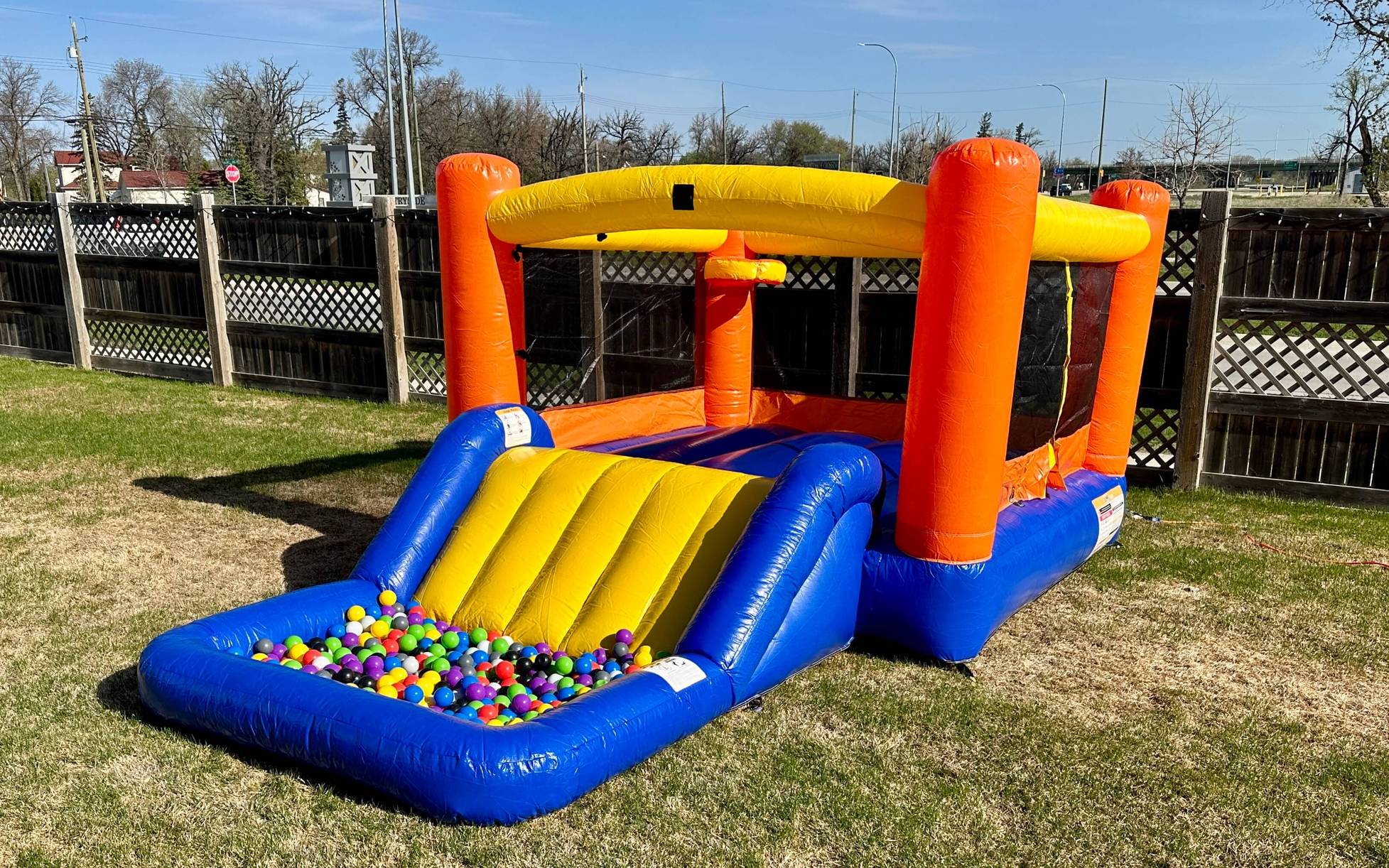 Children's orange bounce house with slide rental in Winnipeg Manitoba