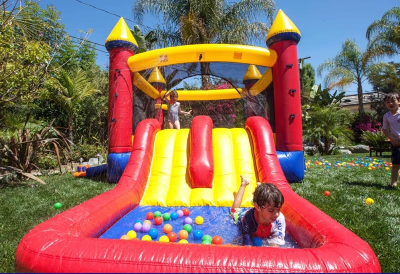 Red Castle slide and bounce house setup for events