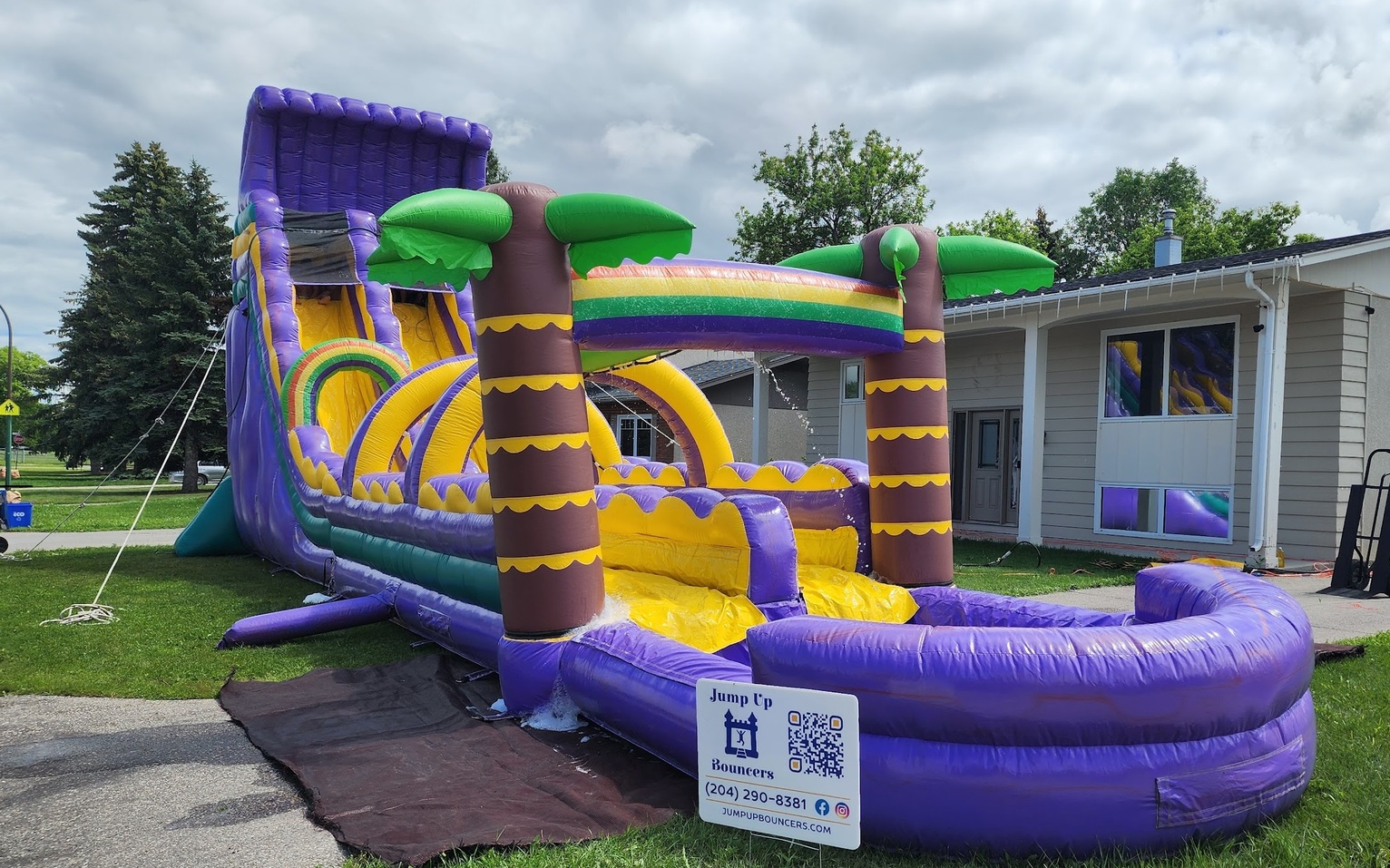 Large inflatable tropical waterslide with splash pool for parties in Winnipeg