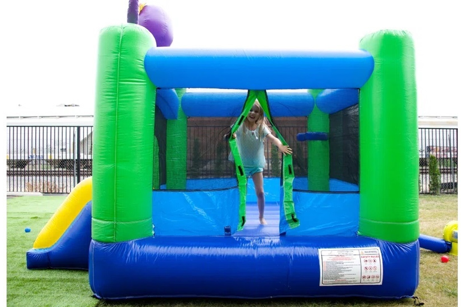 Back view of Octopus Bounce House With Slide rental with netted walls in Winnipeg