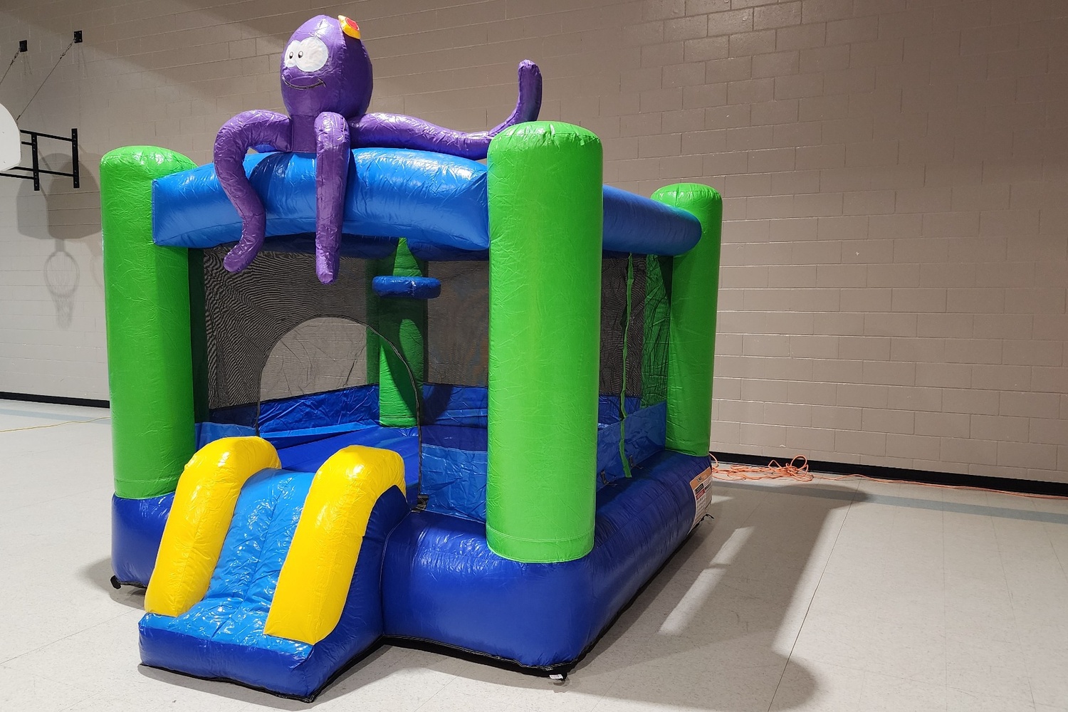 Side angle of Octopus Bounce House With Slide indoor rental for kids parties in Winnipeg